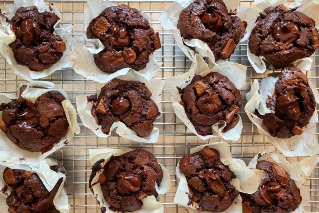 Olympic Village double chocolate muffins on a plate, surrounded by athletes’ empty wrappers
